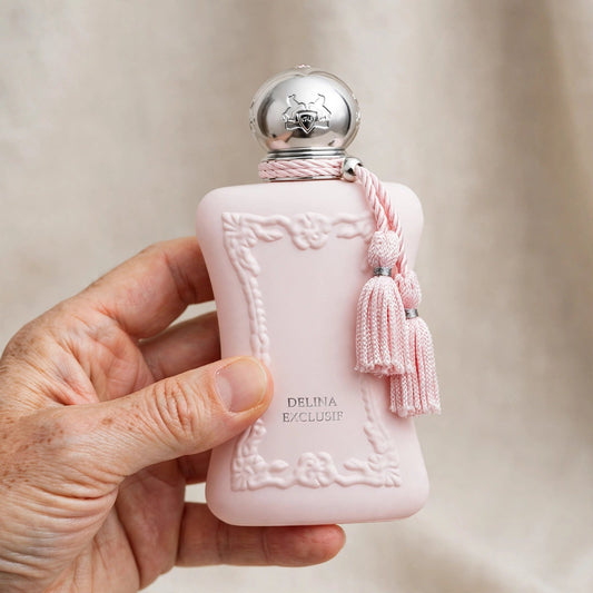 Hand holding Parfums de Marly Delina Exclusif perfume bottle