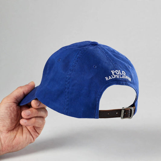 Hand holding the Polo Ralph Lauren royal blue cap