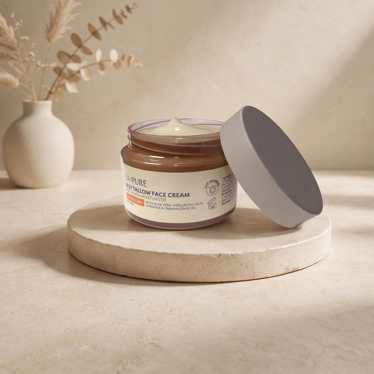 LA Pure Beef Tallow Face Cream jar in a warm beige studio