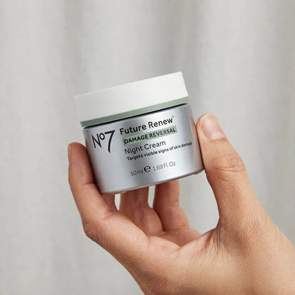 Hand holding the No7 Future Renew damage reversal night cream